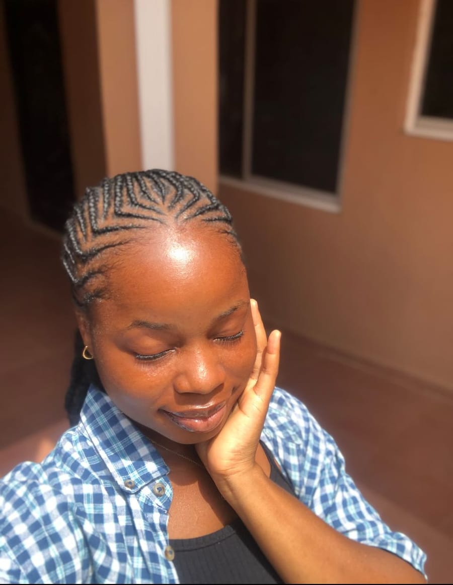 Close feed-in cornrows with a fanned parting across the crown