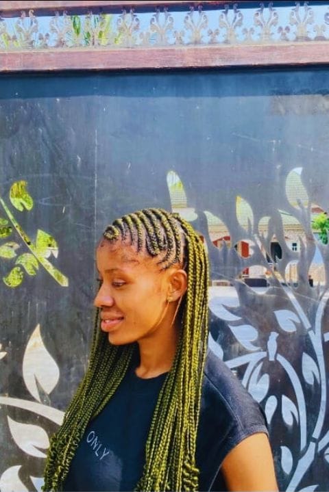Side profile of long olive-toned knotless braids